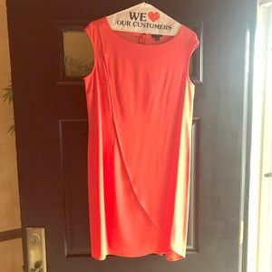 Orange dress with drape in front.